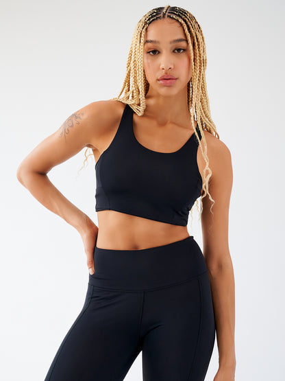 Wildtrails Econyl Bra noir, vue de face, avec design épuré et encolure clean.